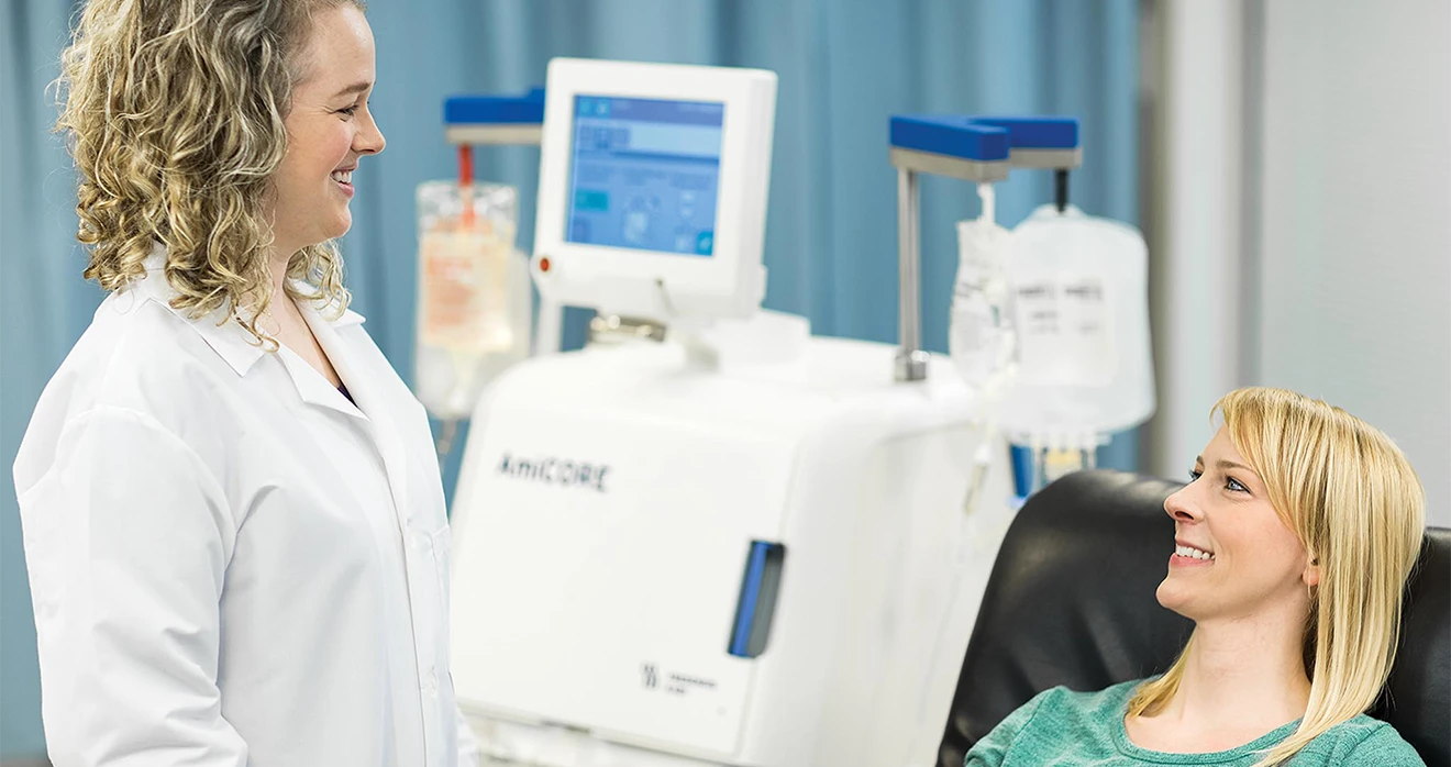 This image depicts a scene where a healthcare professional, possibly wearing a nurse's or medical technician's outfit and standing next to a piece of diagnostic equipment, is interacting with a patient.